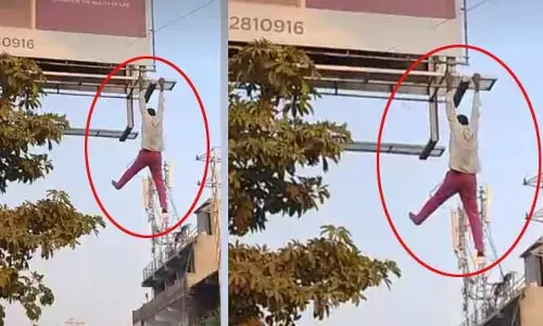 టీ హోర్డింగ్ ఎక్కి ఆత్మహత్యాయత్నం (వీడియో)