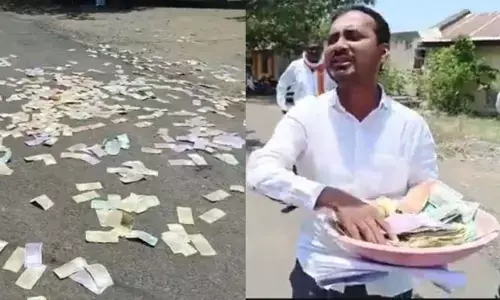 రోడ్డు మీద కరెన్సీ నోట్లు విసురుతూ యువకుడి హల్ చల్.. వామ్మో అసలు కారణం అదా..?