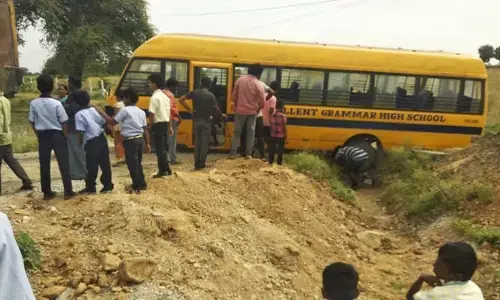 రోడ్డు కల్వర్టు లో పడ్డ స్కూల్ బస్సు