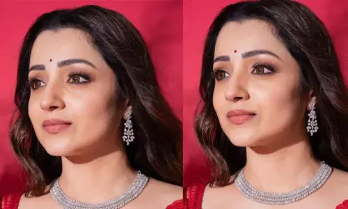 Trisha Krishnan looks cool in red saree