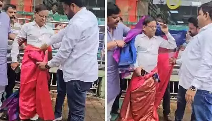 కాంగ్రెస్ పార్టీ సీనియర్ నాయకుడికి చీర కట్టిన బీజేపీ నేతలు.. ఎందుకంటే? కాంగ్రెస్ పార్టీ సీనియర్ నాయకుడికి చీర కట్టిన బీజేపీ నేతలు.. ఎందుకంటే?