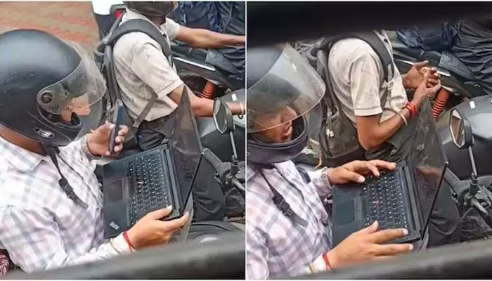 ట్రాఫిక్ జామ్లోనూ ఆగని పని.. బైక్పైనే ల్యాప్టాప్ తెరిచిన ఉద్యోగి! వైరల్ ట్రాఫిక్ జామ్లోనూ ఆగని పని.. బైక్పైనే ల్యాప్టాప్ తెరిచిన ఉద్యోగి! వైరల్